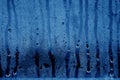 Condensation drops on glass in navy blue tone. Royalty Free Stock Photo