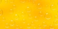 Condensation water or beer droplets on glass yellow background. Rain or dew drops on window, air bubbles or soap spheres Royalty Free Stock Photo