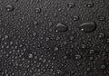 Condensation water drops on black glass background. Rain droplets with on dark surface. Abstract wet texture Royalty Free Stock Photo