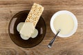 Condensed milk poured on puffed rice in saucer, spoon in bowl with milk on wooden table. Top view Royalty Free Stock Photo