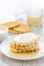 Condensed milk and waffles on a table. Royalty Free Stock Photo