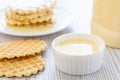 Condensed milk and waffles on a table. Royalty Free Stock Photo