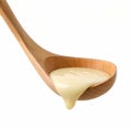 condensed milk in wooden ladle