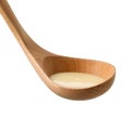 condensed milk in wooden ladle