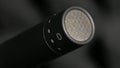 Condenser microphone in music and sound recording studio, gray background, close up.