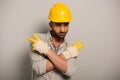 Workman in yellow helmet and gloves