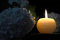 Condolence card with memorial candle and white flowers