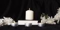Condolence card. A white memorial candle with white flowers and book. The funeral, the sadness Royalty Free Stock Photo