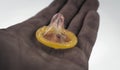 Close-up of a condom in his hand. Contraceptive protection again