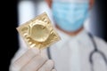 Condom in doctor hand close up, safe sex during coronavirus pandemic Royalty Free Stock Photo