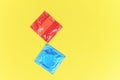 Condom isolated on yellow background / Colorful condom pack for birth control contraceptive means prevent pregnancy or sexually