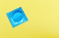 Condom isolated on yellow background - Colorful condom pack for birth control contraceptive means prevent pregnancy or sexually