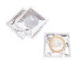 Condom with open pack on white