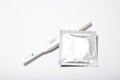 Condom and pregnancy test on a white background. Unplanned pregnancy. Safe sex