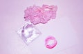 Garters, kiss and condom on white background