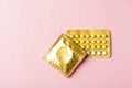 Condom in wrapper pack and contraceptive pills blister Royalty Free Stock Photo