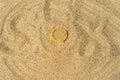 Condom on the yellow sand, background Royalty Free Stock Photo