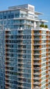 Condominium building. Exterior of a modern high-rise multi-story apartment building condo facade, windows and balconies Royalty Free Stock Photo