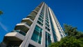 Condominium - place to live, rising tower into blue summer sky. Royalty Free Stock Photo