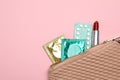 Condoms, birth control pills and lipstick in purse on background, top view with space for text. Safe sex
