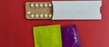 Condoms and birth control pills on red background. Safe sex