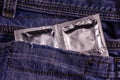 Condoms in a pocket of the blue jeans