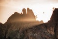 A condor Gymnogyps californianus flying in Pinnacles National Park as sun rays shine through the rock formations. Golden light