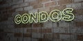 CONDOS - Glowing Neon Sign on stonework wall - 3D rendered royalty free stock illustration