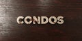 Condos - grungy wooden headline on Maple - 3D rendered royalty free stock image