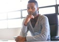 Conducting business with confidence. Portrait of a young businessman sitting at his desk in an office. Royalty Free Stock Photo