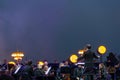 Conductor directing symphony orchestra with performers on background Royalty Free Stock Photo