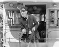 Conductor on a horse drawn streetcar holding the reins