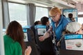 Conductor of a passenger bus sells the tickets. Russia