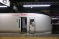 Conductor peering through the window of a high speed Narita Express train Royalty Free Stock Photo