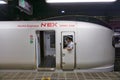 Conductor peering through the window of a high speed Narita Express train Royalty Free Stock Photo