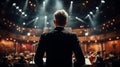 A conductor stands in front of an orchestra in a concert hall, facing away from the audience Royalty Free Stock Photo
