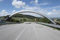 Conduit that transport the energy of steam crosses the road, near Larderello, Tuscany, Italy