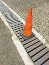 The cone that crosses over the gutter grille is made of iron. With cement block floor. Royalty Free Stock Photo