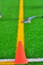 Cone & lacrosse stick on a turf field