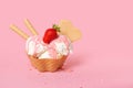 cone with scoops of ice cream strewed sprinkles, poured with glaze and decorated strawberries on pink background Royalty Free Stock Photo