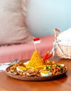 Cone Shaped Yellow Padang Rice Called Nasi Tumpeng with Indonesian National Flag on Top of For Independence Day Celebration Royalty Free Stock Photo