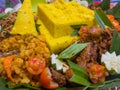 Cone-shaped yellow rice is an Indonesian traditional food, called Nasi Tumpeng. Royalty Free Stock Photo