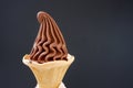 A cone of soft chocolate ice cream on dark background with copy space Royalty Free Stock Photo