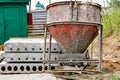 Cone tank for conveying and pouring concrete in monolithic construction by crane. A capacity for transporting concrete. Reinforced