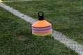 Cones in football field. Coath arranged colorful markers in trainning grassfield of football soccer stadium Royalty Free Stock Photo