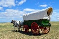 A conestoga wagon pulled by team of horses