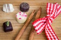 Confection of Holiday chocolate truffles. Mini pralines decorated with cinnamon sticks and red and white ribbon. Royalty Free Stock Photo
