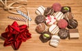 Chocolate pralines with two candles and red ribbon arranged on table. Royalty Free Stock Photo