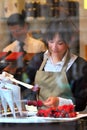 Confectionary worker pouring hot chocolate on strawberries. Royalty Free Stock Photo