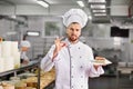 Confectioner with a cake in the bakery.